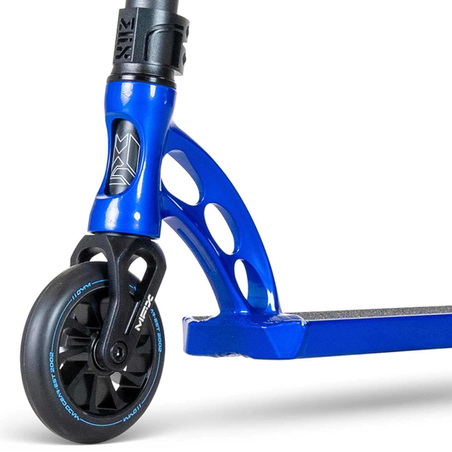 Close-up of the Madd Gear (MGP) VX Origin III 450 Complete Stunt Scooter in Steel Blue, featuring a black wheel with light blue accents on a metal frame with circular cutouts. The glimpse of the deck highlights its textured grip surface, perfect for park riders looking for stability and style.