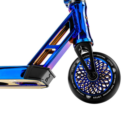 A close-up of the rear wheel and deck of the Root Industries Type R GT Complete Stunt Scooter - Blu-Ray showcases its shiny blue and orange finish. The wheel features an intricate lattice pattern, highlighting the futuristic and metallic elements synonymous with Root Industries' design.