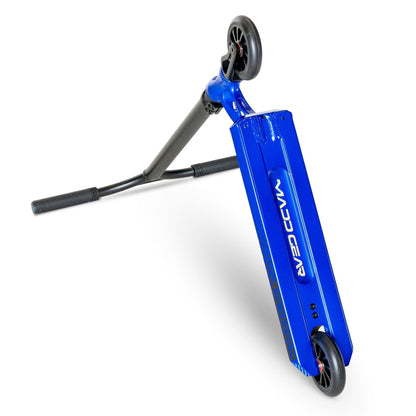 The MGP VX Origin III 450 Complete Stunt Scooter in Steel Blue with black handles and wheels is shown, featuring lightweight aluminum handlebars. It rests on its kickstand, tilted to the right, with the Madd Gear brand name visible against a white background.