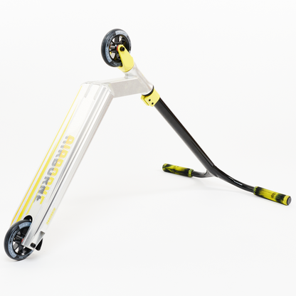 The Dominator Airborne Complete Stunt Scooter, tailored for riders from intermediate to professional levels, showcases an anodised silver deck made from military-grade 6061 T6 aluminum. It comes with black handlebars and yellow wheel accents, artfully set against a white backdrop with the word "airborne" on the deck.