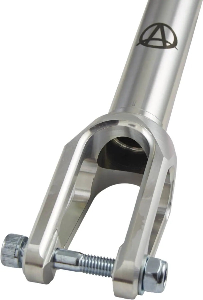 A close-up of the Apex Quantum Lite SCS/HIC Stunt Scooter Forks in Raw Silver, made from durable 7075 aluminum. The scooter fork features a sleek U-shaped design with secure attachment bolts. The Apex logo is positioned on the shaft above, enhancing its polished surface, which shines with a reflective finish.