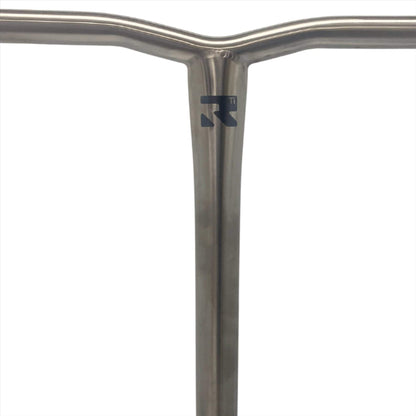 Featuring a close-up of a T-shaped metallic handlebar, the Root Industries AIR Titanium Oversized HIC Stunt Scooter Bars present a small brand logo. This lightweight scooter bar is distinguished by its clean, minimalist design and showcases a smooth, brushed raw finish set against a plain white background.