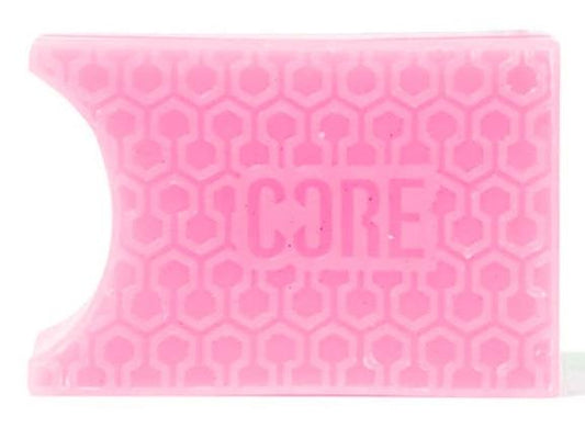 The CORE Epic Skate Wax - Pink from CORE is a rectangular wax with a honeycomb pattern and a curved notch on one side. It features pre-grooved shapes for improved grip, and "CORE" is embossed in the center.