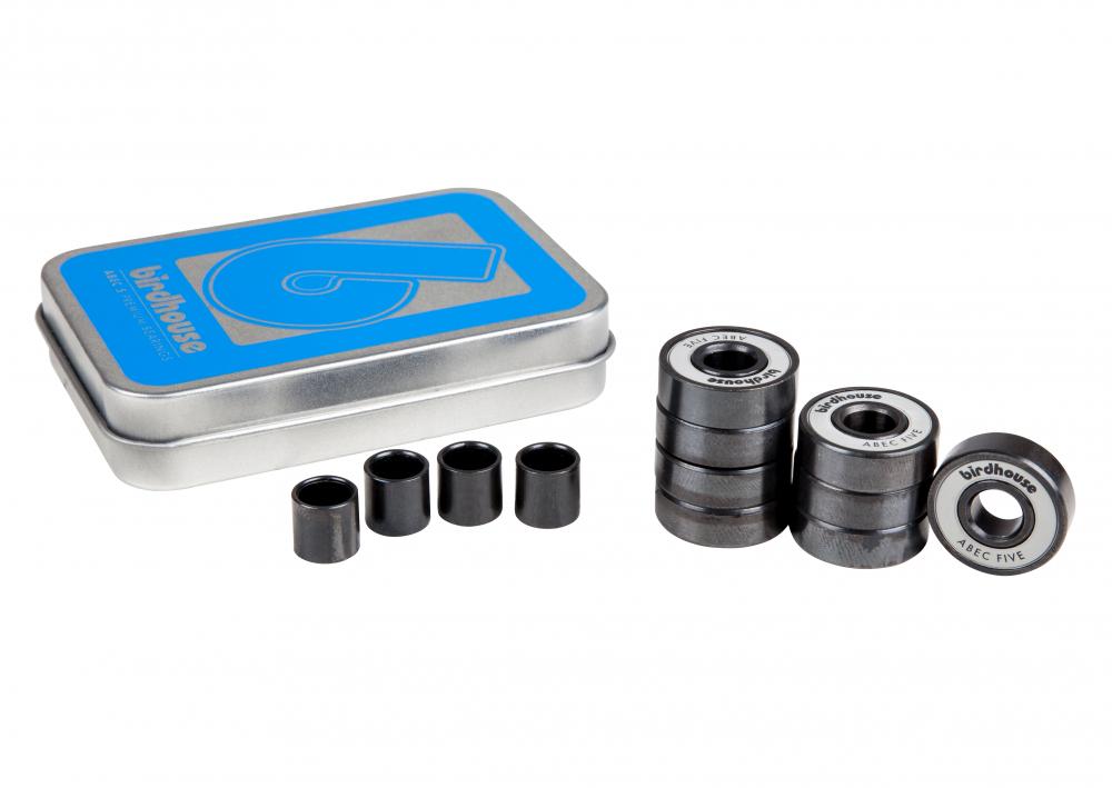 This set of Birdhouse ABEC 5 Grey Skateboard Bearings includes eight high-quality bearings packaged in a branded tin case with a sleek silver finish and blue design. The bearings are arranged in an organized stack to ensure top performance, accompanied by four individual spacers neatly placed in front.