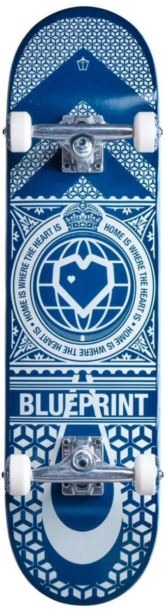 A Blueprint Home Heart Complete Skateboard, sized at 8" x 31.5", showcases a blue and white geometric design adorned with a crown and heart emblem, alongside the phrase "Home is where the heart is." Featuring the "Blueprint" logo near the base, this skateboard is ideal for practicing new technical tricks on its smooth wheels.