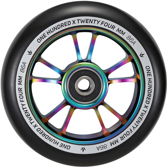 Close-up of a Blunt Envy 100mm stunt scooter wheel showcasing an aluminium core with an oil slick neochrome finish. The outer black rim is inscribed with "ONE HUNDRED X TWENTY FOUR MM 86A," and it is equipped with smooth ABEC 9 bearings for optimal performance.