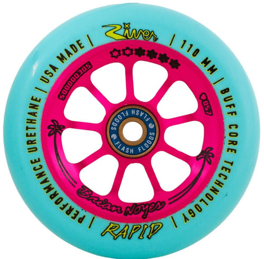 Introducing the River Rapids Signature Brian Noyes 110mm Stunt Scooter Wheel in Teal and Pink, featuring a vibrant turquoise outer rim and a pink core. This wheel is adorned with the names "River," "Brian Noyes," "Flash Floods," and "Rapid," complete with BUFF Core Technology and decorated with an eye-catching star-palm tree design.