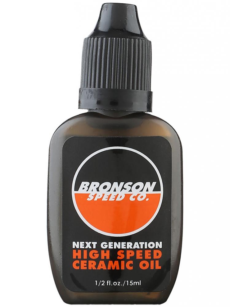 A compact dark bottle with a black screw cap showcases a label stating "Bronson Speed Co. High Speed Ceramic Bearing Oil" in bold white and orange text, emphasizing its wear protection benefits. The bottle contains 1/2 fl. oz. (15 ml).