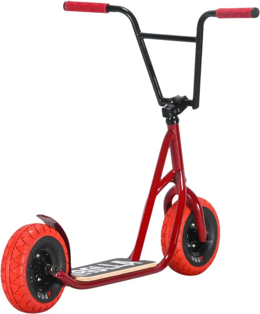 The Rocker Rolla Big Wheel Complete Scooter - Red, by the brand Rocker, is a vibrant kick scooter boasting black handlebars and a platform. It features large red tires and a sturdy frame ideal for off-road adventures, echoing the durability found in mini BMX bikes. The grip handles are black with eye-catching red tips, making it perfect for daring riders.