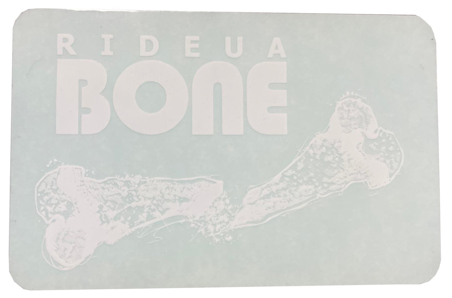 A rectangular sign featuring the bold, white UrbanArtt logo "RIDEAU BONE" set against a light blue background captures the essence of UrbanArtt's scootering vibe. Accompanying the text is a stylish, white illustration of a bone, echoing the design of the UrbanArtt Bone Sticker - White, making it an ideal choice for scooter enthusiasts.