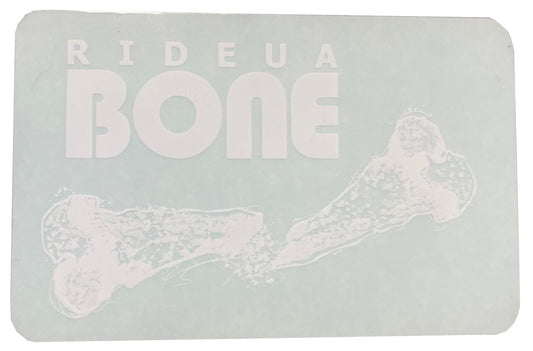 A rectangular sign featuring the bold, white UrbanArtt logo "RIDEAU BONE" set against a light blue background captures the essence of UrbanArtt's scootering vibe. Accompanying the text is a stylish, white illustration of a bone, echoing the design of the UrbanArtt Bone Sticker - White, making it an ideal choice for scooter enthusiasts.