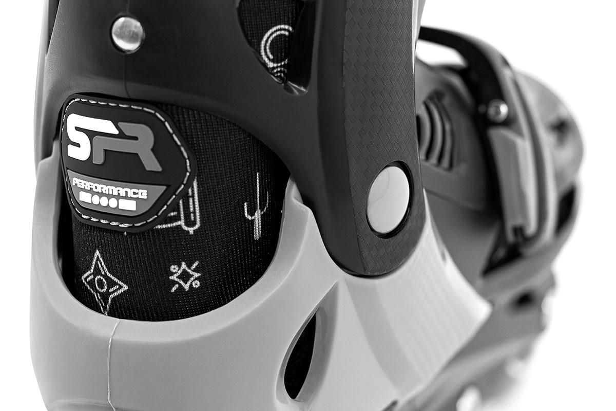 Close-up of a gray and black rollerblade boot, focusing on the back. The SFR Cyclone II Adjustable Inline Skates - Ninja by SFR showcase a performance logo alongside various small graphic symbols like tools and geometric shapes on the side fabric. They are equipped with an adjustable sizing system to ensure a perfect fit.