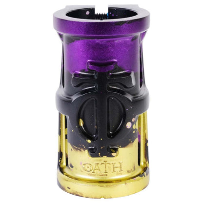 The Oath Cage V2 4 Bolt SCS Oversized Stunt Scooter Clamp showcases a striking combination of black, purple, and yellow colors. Made from lightweight 6061 T6 Aluminium, it features an engraved design with the brand name "OATH" elegantly etched at the bottom.