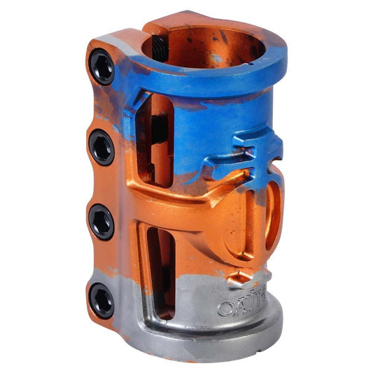 The Oath Cage V2 4 Bolt SCS Oversized Stunt Scooter Clamp in Orange, Blue, and Titanium from Oath is made with robust 6061 T6 Aluminium. It incorporates four black bolts on the side and showcases a distinctive front emblem for both aesthetic appeal and weight efficiency.