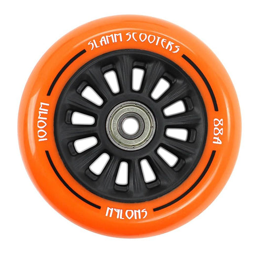 A close-up image of the Slamm Nylon Core 100mm Stunt Scooter Wheel in orange shows off its sleek black spokes and a central ABEC 9 Chrome Bearing. The rim, made from durable polyurethane composite, features labels including "Slamm," "100mm," and "88A NyloNS.