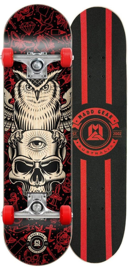 The Madd Gear (MGP) MGP Pro Series Watcher Red / Black Complete Skateboard - 8" x 31" features an owl and skull design with an all-seeing eye. Another option displays a black and red geometric pattern with "Madd Gear Australia Est. 2002." Both skateboards are crafted with 9-ply maple decks, equipped with red wheels, and feature smooth Carbon Steel ABEC 3 bearings for an outstanding ride.