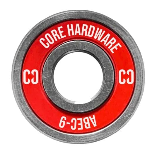 Close-up of a round metal bearing with a red center, adorned with "CORE" and "ABEC 9" in white text—a perfect choice for scooter bearings. The initials "CC" are also visible, and the shiny metal indicates that it is likely new and unused.