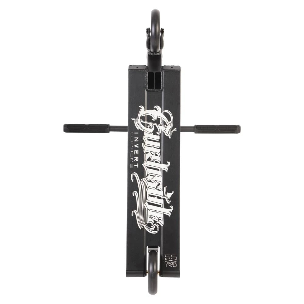 Top view of the Invert Curbside Complete Street Stunt Scooter in black, showcasing intricate white lettering on the deck. It features chromoly steel bars and alloy core wheels, along with four pegs and a rectangular deck design, accentuating its sturdy and sleek build.