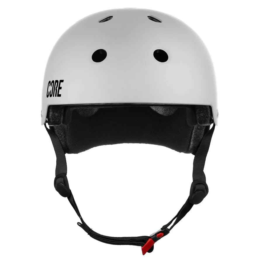 Check out the CORE Action Sports Skate/Scooter Helmet in white, a premium helmet from CORE. This helmet combines comfort and style with its top ventilation holes and an adjustable black chin strap featuring a red buckle for the perfect fit. The helmet proudly displays "CORE" branding on the side.