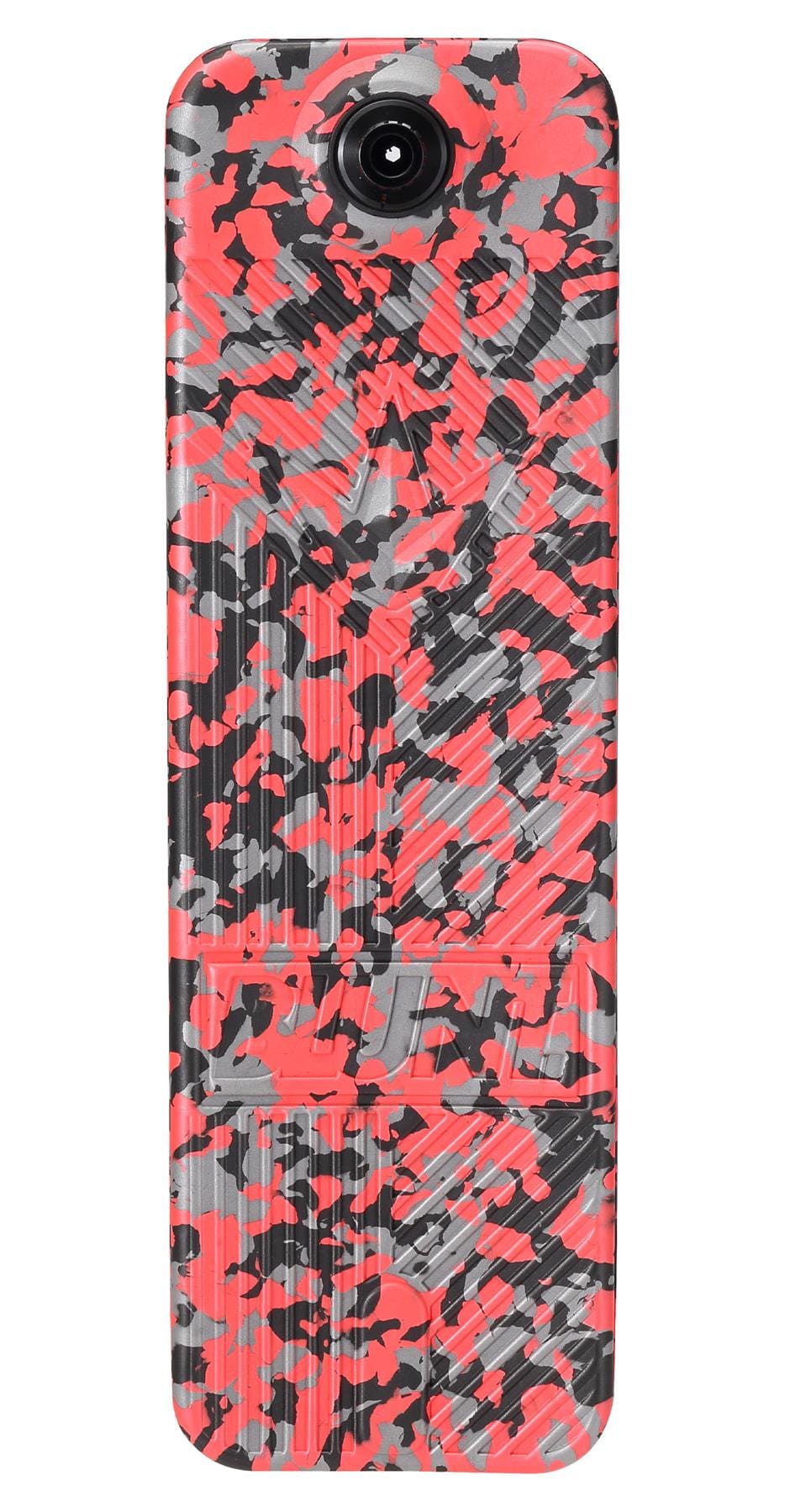 A rectangular object with a vibrant, abstract pattern in shades of red, black, and gray similar to the Blunt Envy TS Pro 7.5 Indoor Trampoline Stunt Scooter - Red Camo. The design includes irregular shapes and lines, featuring a circular lens at the top center, ideal for individuals aiming for a customizable scooter experience.