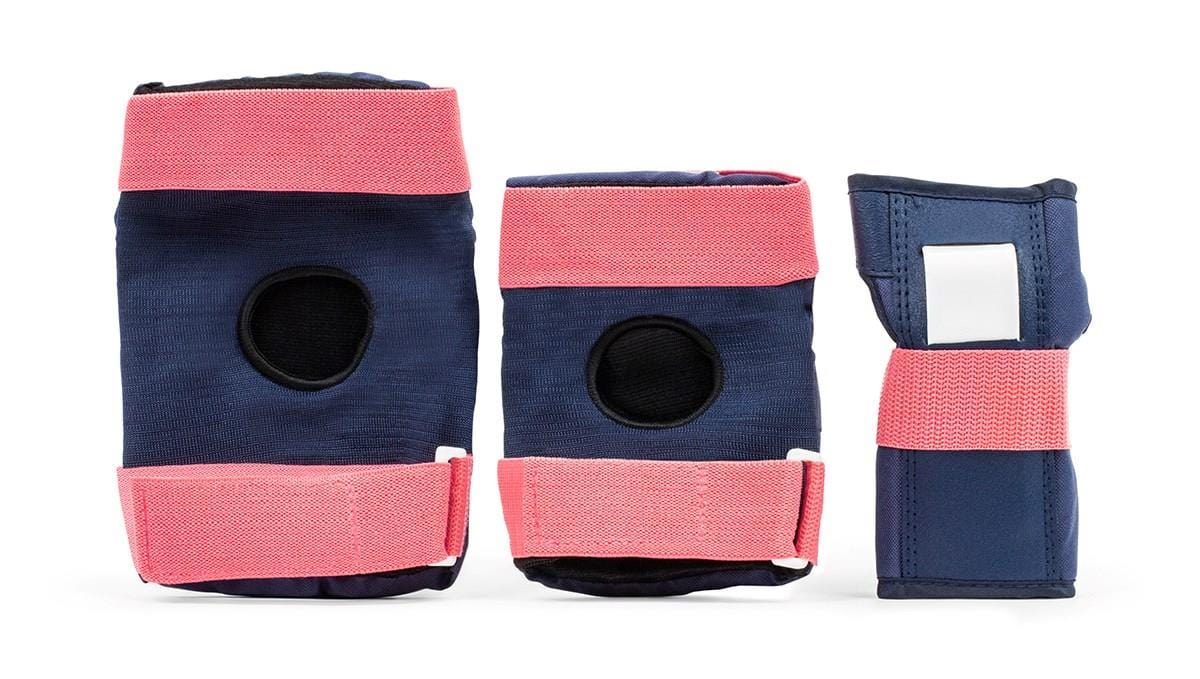 Displayed is the REKD Heavy Duty Triple Skate Protection Pad Set in blue and pink, which includes two knee pads with circular cutouts, a wrist guard, and a pair of elbow pads designed for optimal comfort and safety.