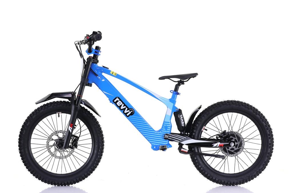 A blue Revvi 20" Kids Electric Balance Bike is shown from the side, featuring thick black tires, disc brakes, and a prominent frame. It includes a suspension fork and a sleek black seat.