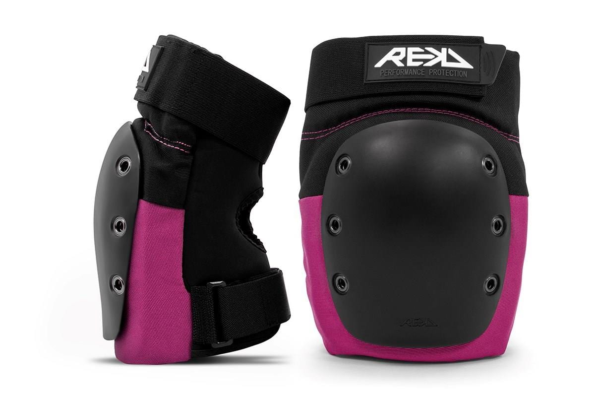 Two REKD Ramp Knee Skate Protection Pads in black and pink, designed with impact-resistant sleek black protective caps. These pads feature adjustable straps and visible stitching, making them perfect for action sports or safety needs. Positioned upright, they exhibit both front and side views.