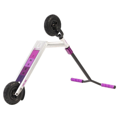 The Invert Supreme Taunt Dirt Scooter in raw, pink, and purple features a fully integrated headset for smooth handling. The scooter is displayed in a dynamic mid-air position, showcasing its robust design and vibrant colors, with the "Invert" brand name visible on the deck.