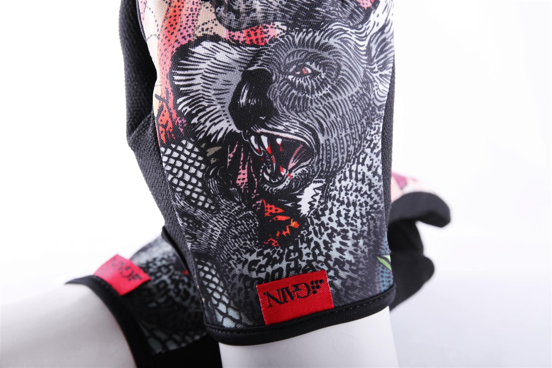 Close-up of the GAIN Protection Resistance Skate Gloves - Dropbear featuring a detailed black and white illustration of a roaring bear with an open mouth. The ARMORTEX fabric ensures durability, while the vibrant red tags add flair. Additionally, enjoy touchscreen compatibility for convenience without sacrificing style.