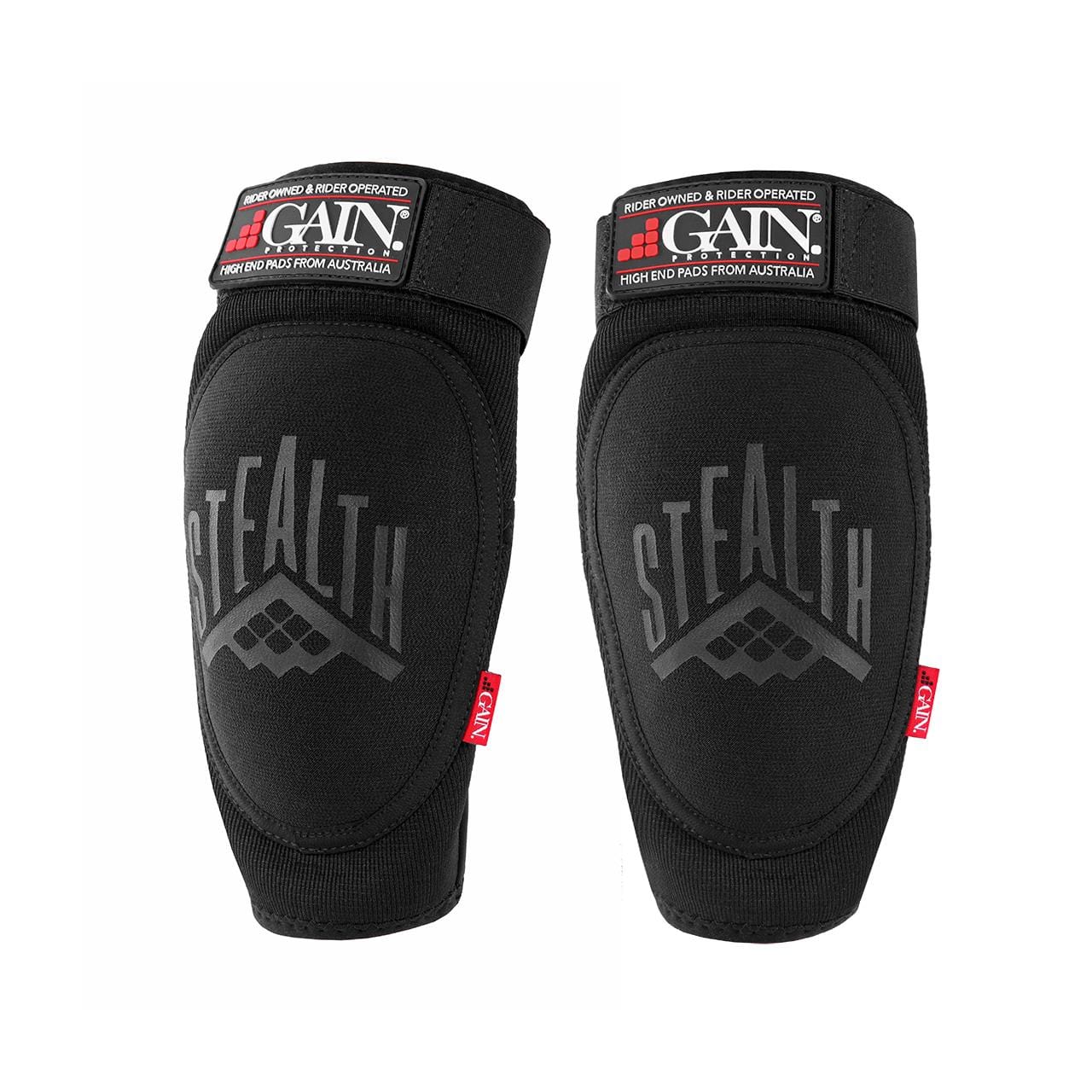 The GAIN Protection Stealth Elbow Skate Pads in Black boast DuraTec neoprene with "STEALTH" prominently displayed. They come with adjustable straps, a red side tag, and KEVLAR-like enhanced durability for unmatched protection.