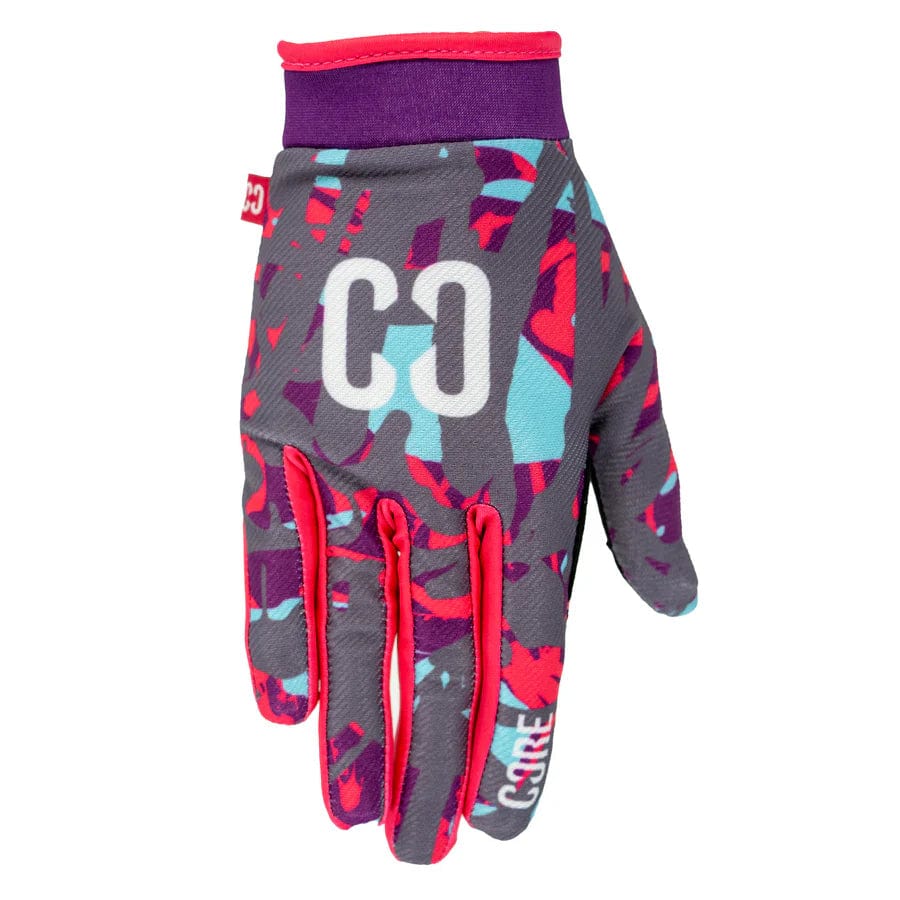 Introducing the CORE Aero Skate Protection Gloves - Neon Splat, vibrant gloves designed with abstract patterns in purple, teal, and red. These gloves feature "CO" initials on the back and are accented with red trims around the wrist and fingers. Plus, they are touch screen friendly, keeping you connected on every ride.