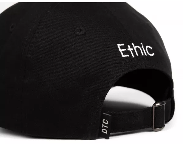 An Ethic DTC 2G1 Cap in black is depicted from the back, showcasing the embroidered Ethic logo in white on the side. The back features an adjustable strap with a metal buckle and a small "DTC" tag, emphasizing its Ethic DTC apparel design.