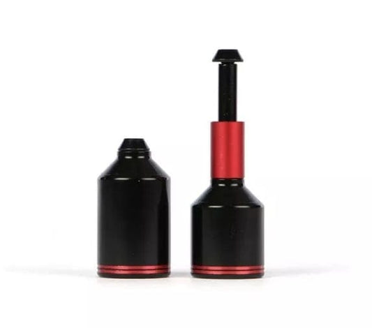 Two Ethic DTC Aluminium Stunt Scooter Pegs in black with red accents are displayed, with one open to expose an inner red component. Made from 7075 T6 aluminium, they have a resemblance to carbon dioxide (CO2) inflators for bicycle tires. Both stand upright against a white background, reflecting the precision of Ethic's design.