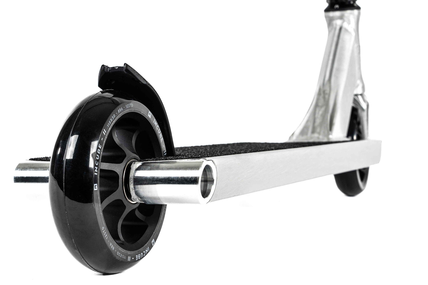 Close-up of the Ethic DTC Pandora Complete Stunt Scooter (L) in brushed silver, showcasing the front wheel and base. Ideal for street riding, it boasts a textured deck and sleek design, featuring a durable black wheel and strong chromoly steel T-bar for enhanced performance.