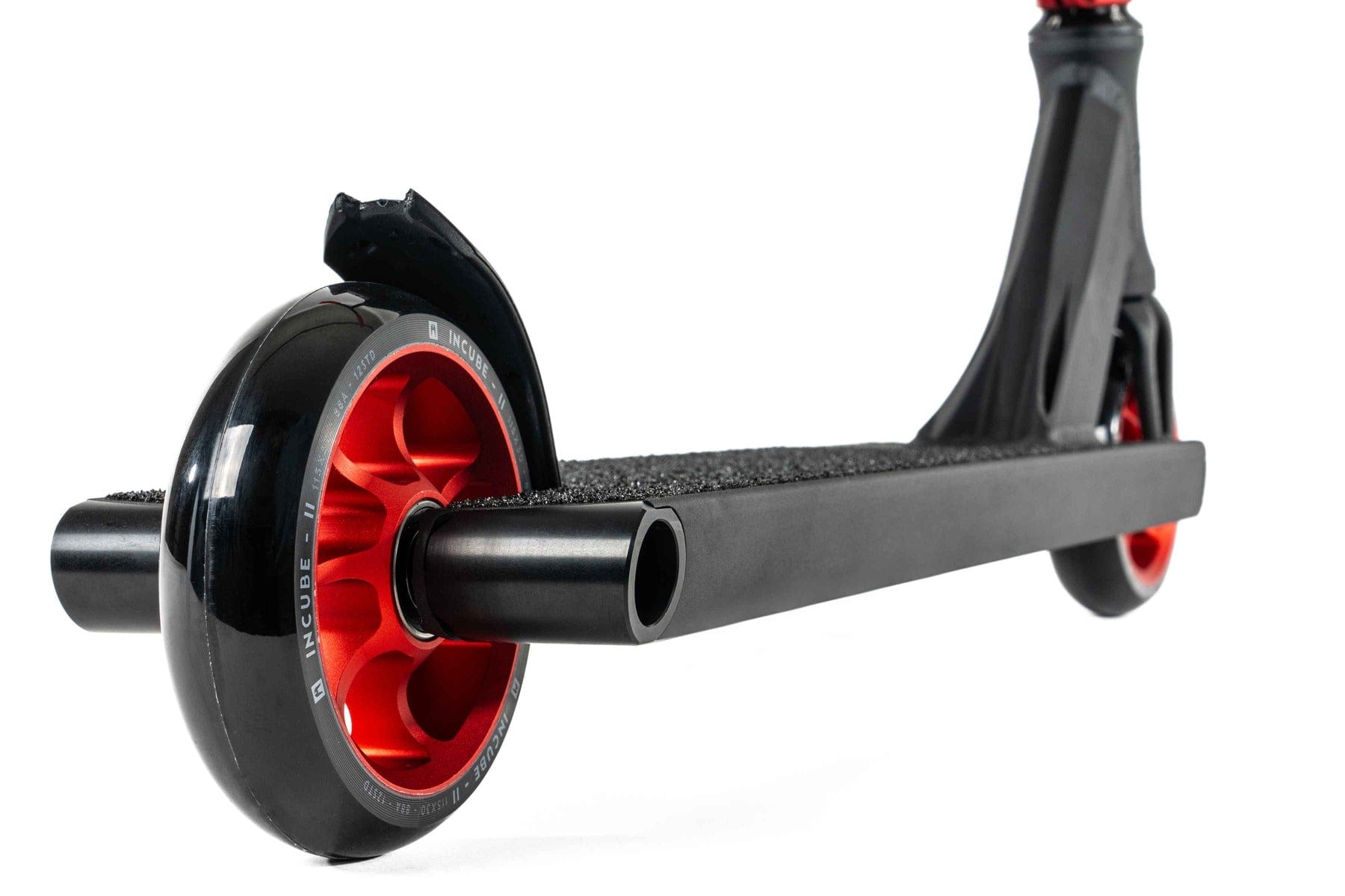 The Ethic DTC Pandora Complete Stunt Scooter (L) - Red features a close-up of its rear section and wheels, showcasing its black textured deck and sleek, modern design. This black scooter comes with red wheels and a durable chromoly steel T-bar, making it perfect for street riding.