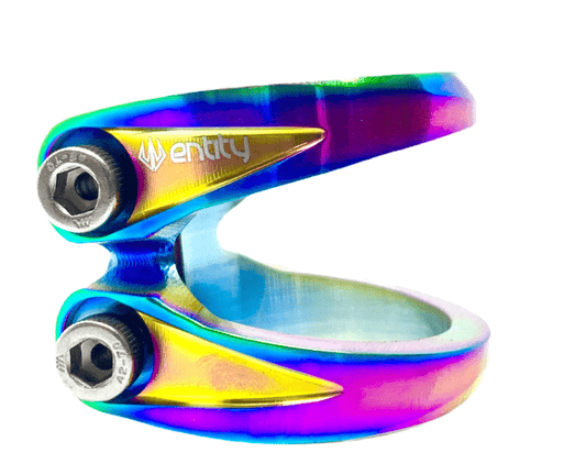 Introducing the Entity Exile 2 Bolt Oversized Stunt Scooter Clamp in Neochrome, a metallic marvel with a rainbow finish. This lightweight and durable clamp bears the "Entity" brand name and features two bolts for secure fastening, combining sleek lines with a modern design.