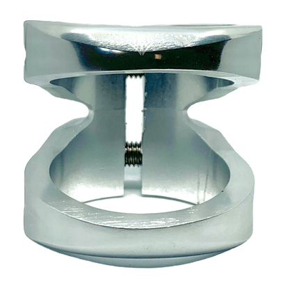 Close-up of a shiny, raw silver metal piece with a unique hourglass shape, likely the Entity Exile 2 Bolt Oversized Stunt Scooter Clamp by Entity, crafted using precision 5-axis CNC machining technology. A threaded screw runs through the center, while its smooth surface reflects light, exhibiting meticulous precision and craftsmanship.