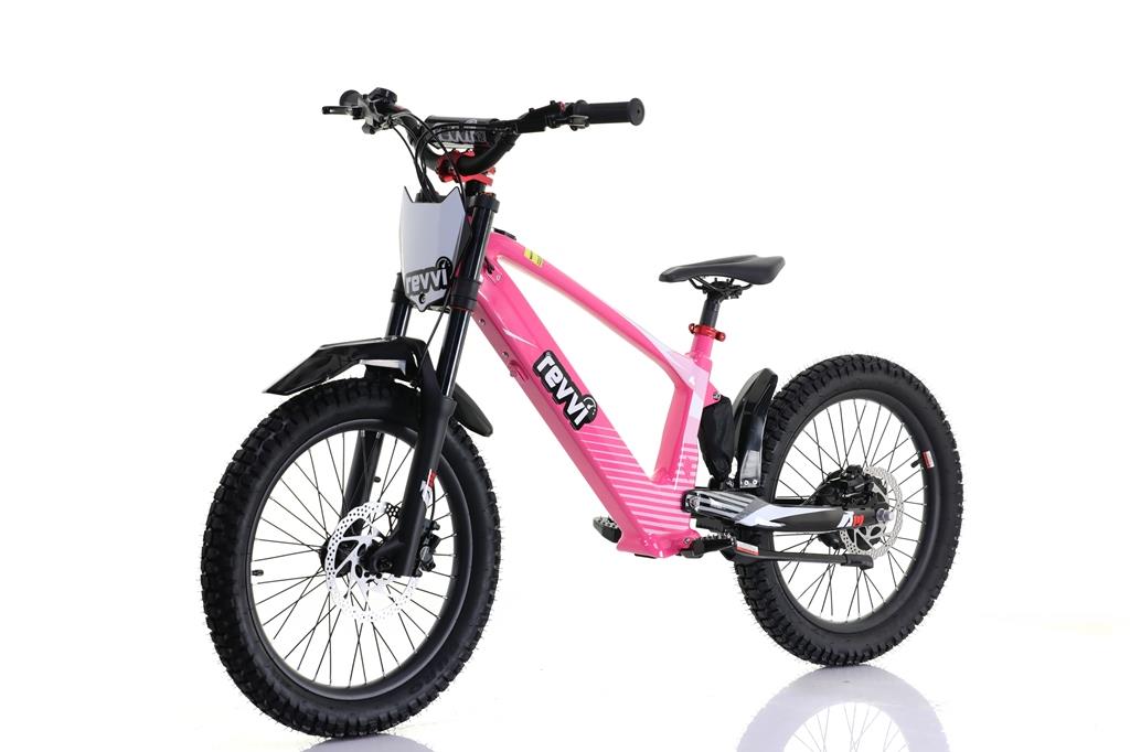 A bright pink Revvi 20" Kids Electric Balance Bike features a sturdy frame, thick black tires, speed settings, suspension fork, and sleek black seat. Set against a white background, it highlights its modern design and off-road capabilities.