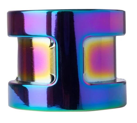 The Core SL Double Bolt Scooter Clamp in Neochrome from CORE is a lightweight, cylindrical metallic object with a hollow center. It showcases a reflective, multicolored surface with iridescent shades of blue, purple, and gold.