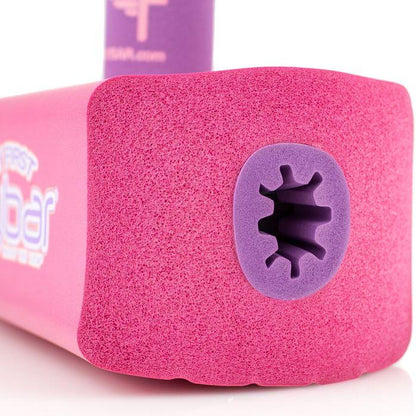 Close-up of the Flybar My First Foam Pogo Jumper in a pink color resembling an active toy for kids. Its textured surface transitions to a purple inner section with a star-shaped opening at the end. A portion of the Flybar logo is visible on the side, enhancing its playful design reminiscent of toddler toys.