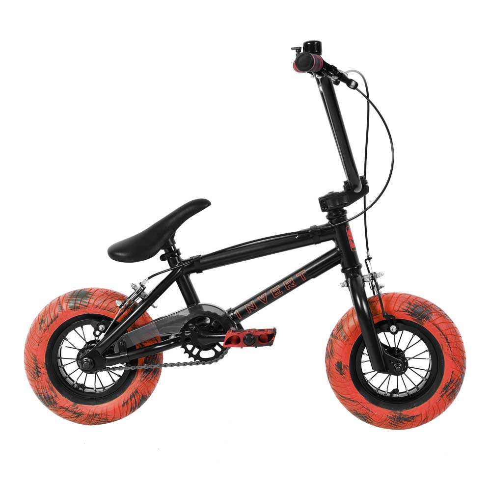 The Invert Supreme Havoc Mini BMX Bike - Black / Red features a compact design ideal for beginner BMX riders, boasting vibrant red and marble-patterned tires, a sturdy frame, and black handlebars. Perfect for action sports, this bike is designed with kids in mind.