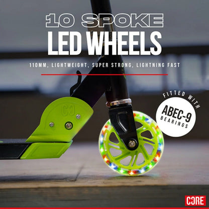 A detailed view of the CORE Foldy Kids LED Foldable Scooter wheel showcases its multicolored, 10 LED-spoke design. This image emphasizes the wheel's 110mm size, lightweight construction, exceptional strength, and high speed thanks to ABEC-9 bearings. The "CORE" logo is prominently displayed in the bottom right corner.