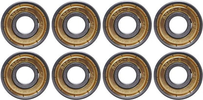 A photo displaying eight Speed Demons ABEC 5 Hot Shot skateboard bearings, arranged in two rows of four. Each bearing showcases a metallic outer ring inscribed with "ABEC-5" and other markings, ideal for any skateboard setup. The inner ring highlights a dark central hole.