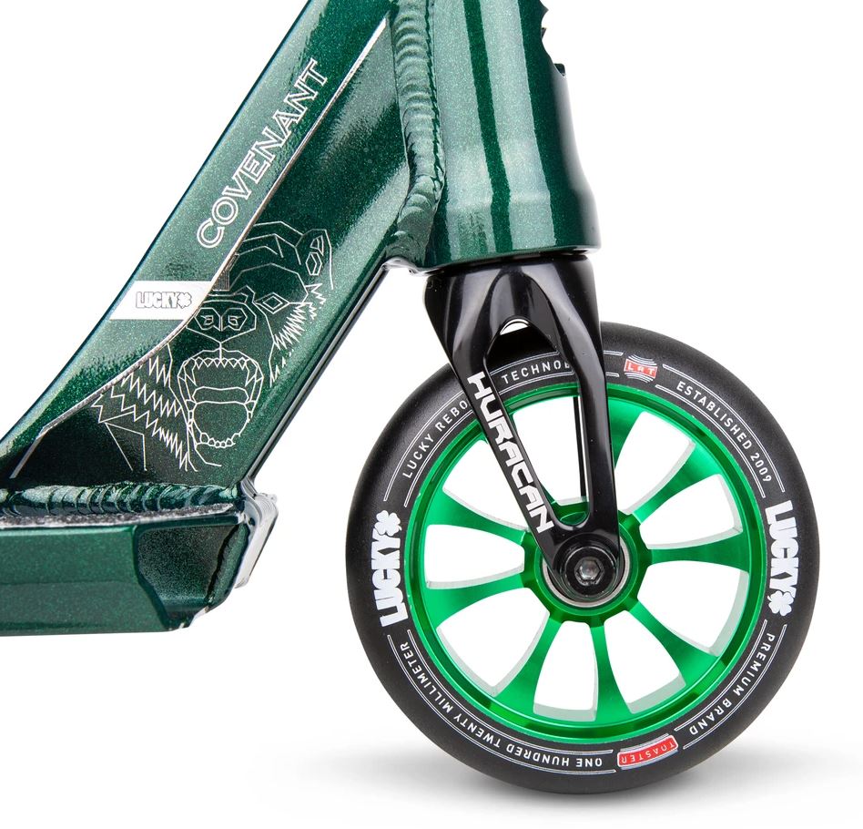 Close-up of the emerald green scooter wheel paired with a black fork, featuring green spokes and branded "Lucky" in white text. The Lucky Covenant 2021 deck displays a stylized graphic of a fierce gorilla. Perfect for stunt scooter enthusiasts, this model is crafted with high-quality aftermarket parts.