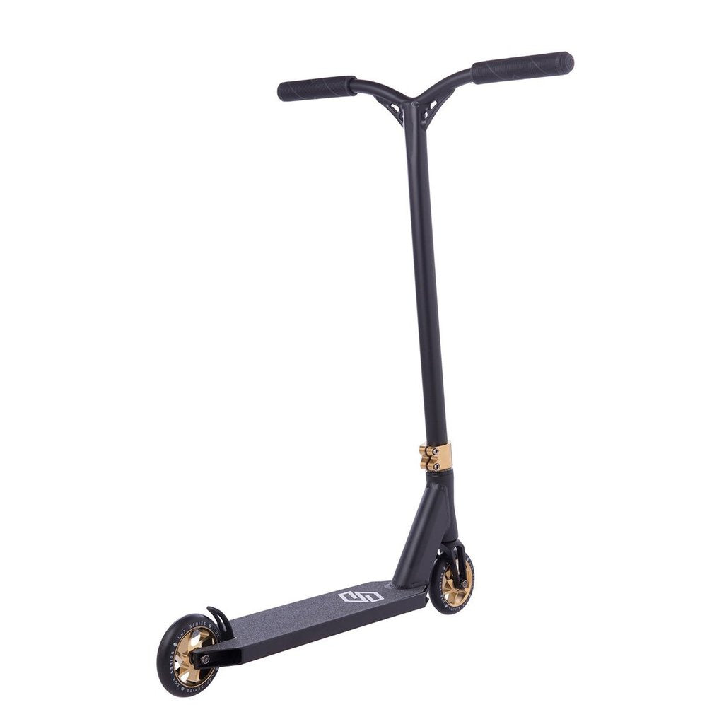 The Striker Lux Pro Complete Stunt Scooter - Gold Chrome by Striker is an elegant, gold-accented aluminum scooter featuring a T-shaped handlebar and black wheels. Its minimalist deck design enhances its lightweight nature, making it stand gracefully upright against a white background.