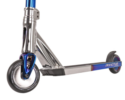 Close-up of the sleek, metallic Root Industries Invictus Complete Stunt Scooter - Afterburner Blu Ray, showcasing a silver deck with "Invictus" printed on the side, black wheels, and a vibrant blue handlebar shaft. Designed for stability and balance, it features premium bearings for a modern, aerodynamic ride.