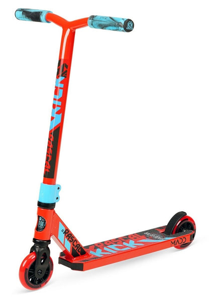 The Madd Gear MGP Kick Mini Pro Rascal IV Complete Stunt Scooter in red and blue is ideal for younger riders. This scooter features bold graphics on both the deck and handlebars, with black and red wheels enhancing its robust, minimalist design.