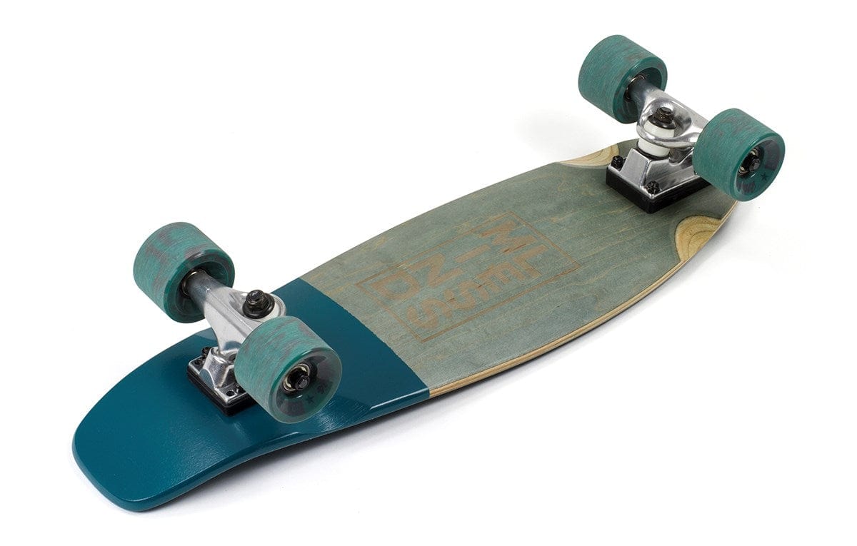 The Mindless Stained Daily Grey Complete Cruiser - 24" x 7" features teal wheels and a coordinating section on the deck, highlighted by wood tones with a printed design. Its sleek appearance is complemented by silver trucks. Perfect as an everyday cruiser board, it is elegantly displayed on a white background.