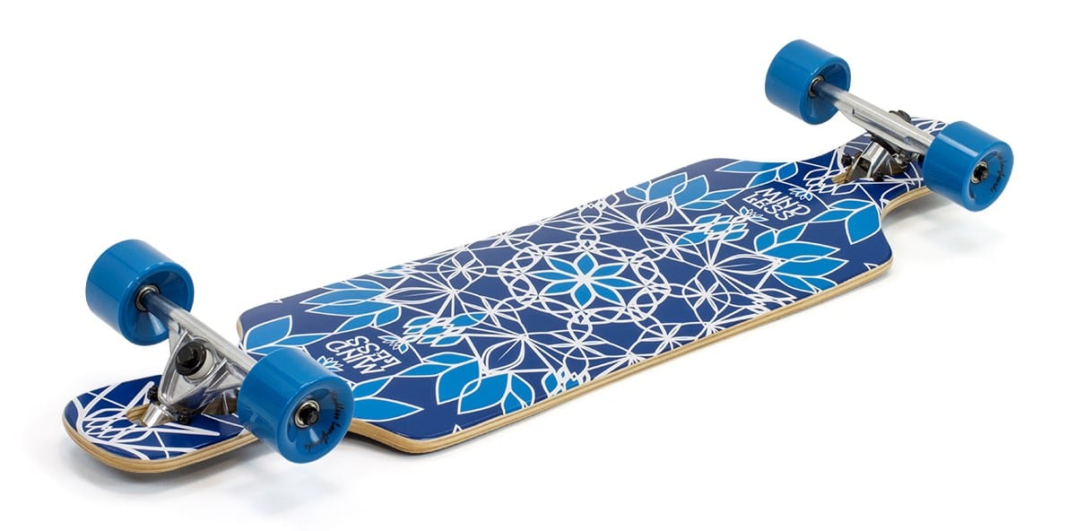 The Mindless Sanke III Blue Complete Longboard, measuring 39" x 9.5", features a geometric floral pattern and blue wheels. Designed for greater stability, it rests on a white background, making it an excellent choice for beginner riders seeking a smooth and secure ride.