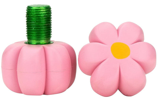 Two erasers shaped like a pink flower and a pink pumpkin. The flower features a yellow center similar to the Moxi Brake Petal Roller Skate Toe Stops in Pink Carnation, while the pumpkin has a green, textured top that resembles a stem. These vibrant and whimsical erasers capture the playful spirit of Moxi Roller Skates for your desk supplies.